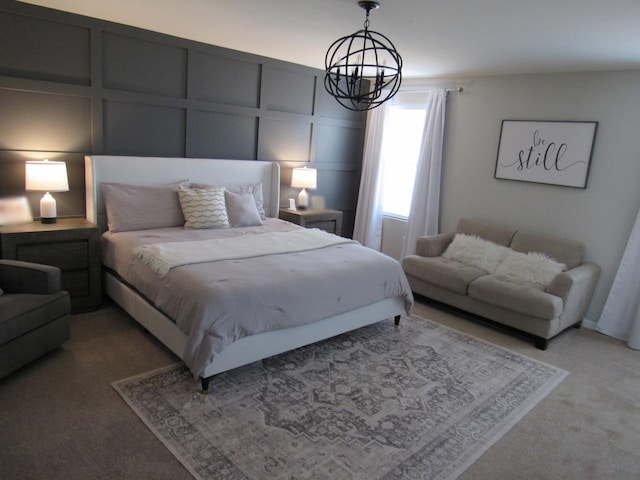 bedroom with a chandelier, a decorative wall, and light colored carpet