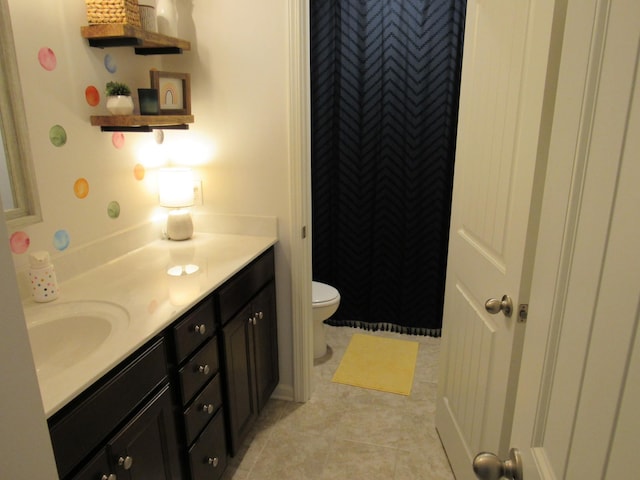 full bath with toilet, tile patterned floors, and vanity