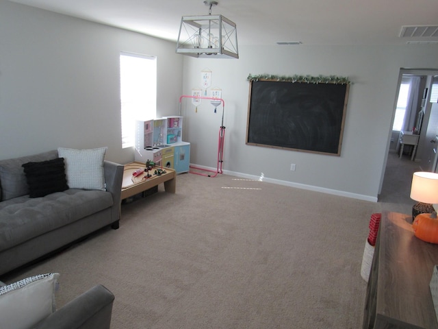 carpeted living room featuring visible vents and baseboards