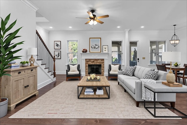 352 Snowden St W, Franklin, TN 37064 - living area featuring ceiling fan, stairway, ornamental molding, dark wood-type flooring, and a fireplace