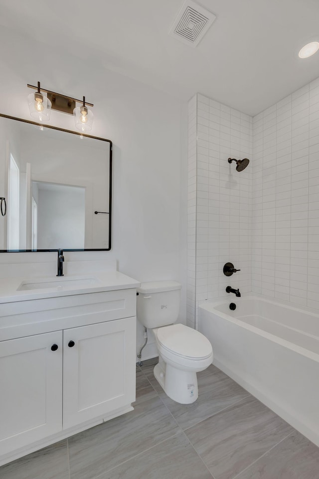 full bathroom featuring visible vents, toilet, bathtub / shower combination, vanity, and tile patterned flooring