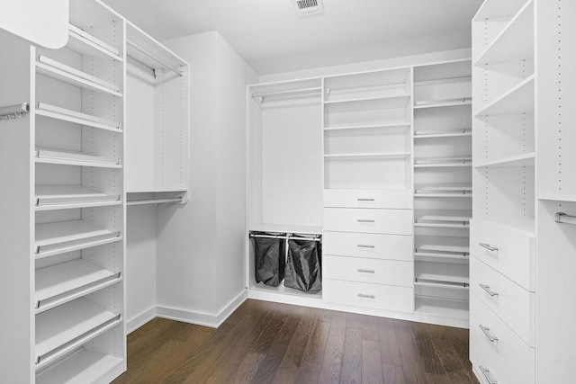 walk in closet with dark wood-style flooring and visible vents