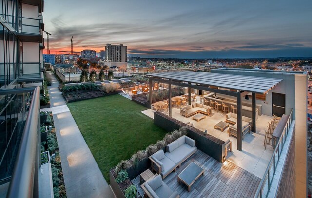 view of yard with an outdoor living space, a patio, and a view of city