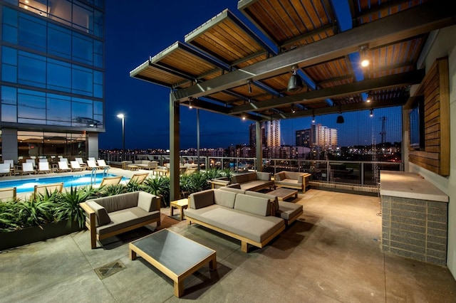patio at twilight featuring an outdoor living space, a view of city lights, and a community pool