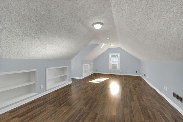 314 Shadowbrook Dr, Smyrna, TN 37167 - bonus room with a textured ceiling, built in features, baseboards, visible vents, and dark wood-style floors