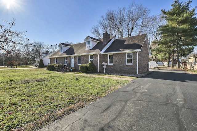 314 Shadowbrook Dr, Smyrna, TN 37167 - cape cod home featuring brick siding, driveway, a front yard, a chimney, and a shingled roof