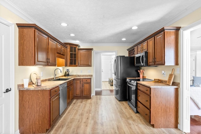 580 Mountain View Dr, Clarksville, TN 37043 - kitchen with glass insert cabinets, light wood-style flooring, a sink, stainless steel appliances, and brown cabinets