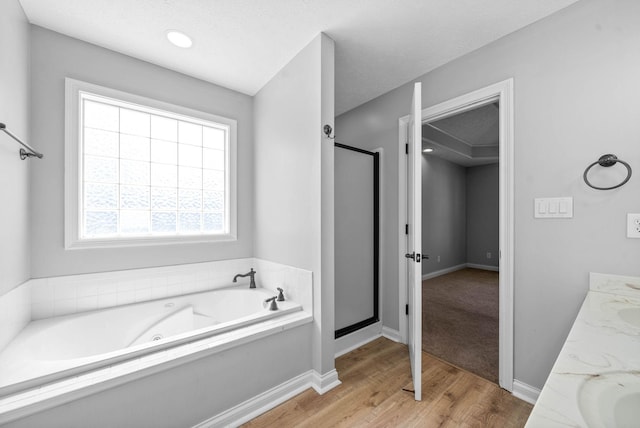 580 Mountain View Dr, Clarksville, TN 37043 - bathroom featuring a jetted tub, baseboards, a stall shower, and wood finished floors