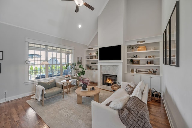 1009 Alpaca Dr, Spring Hill, TN 37174 - living area featuring built in features, baseboards, ceiling fan, a fireplace with flush hearth, and high vaulted ceiling