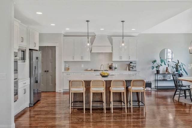 1009 Alpaca Dr, Spring Hill, TN 37174 - kitchen with white cabinetry, custom exhaust hood, dark wood-style flooring, light countertops, and high end fridge