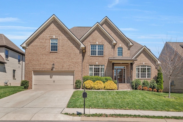 1009 Alpaca Dr, Spring Hill, TN 37174 - traditional home featuring brick siding, an attached garage, a front lawn, and concrete driveway
