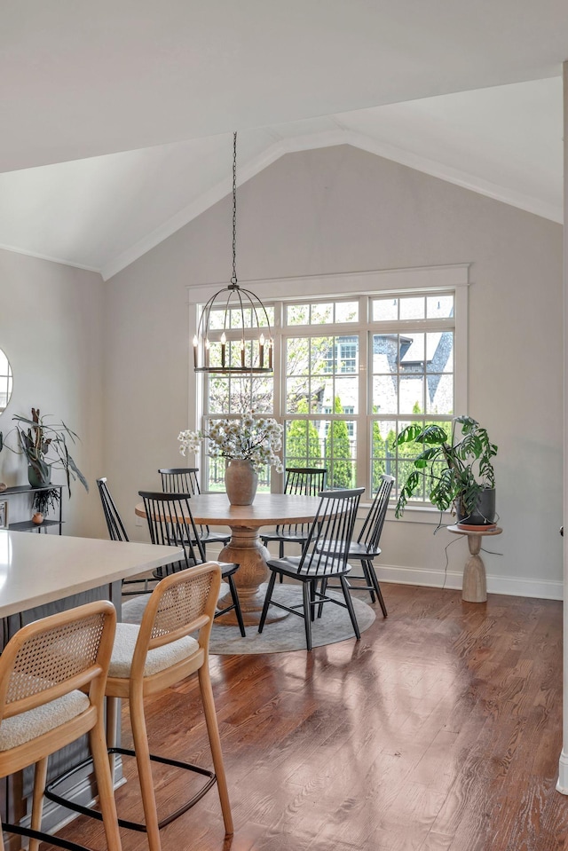 1009 Alpaca Dr, Spring Hill, TN 37174 - dining area with baseboards, a chandelier, crown molding, lofted ceiling, and wood finished floors