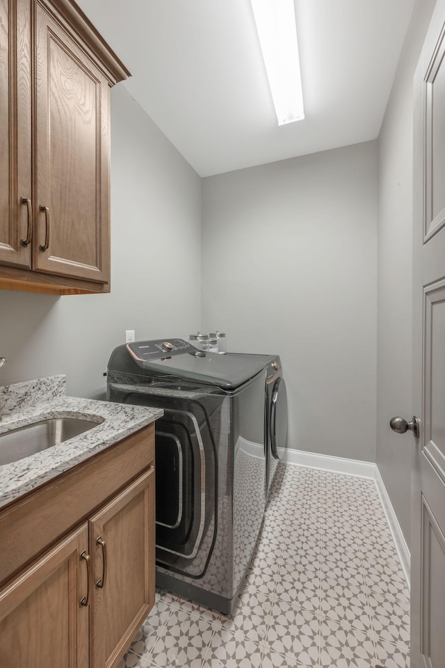 1009 Alpaca Dr, Spring Hill, TN 37174 - laundry room featuring washer and clothes dryer, a sink, cabinet space, and light floors