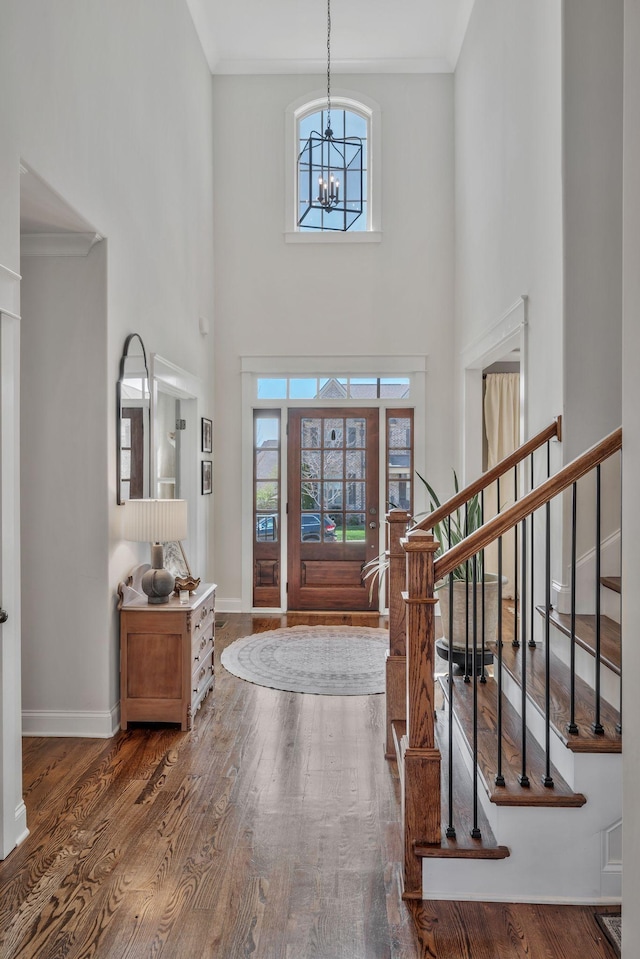 1009 Alpaca Dr, Spring Hill, TN 37174 - entrance foyer featuring an inviting chandelier, crown molding, stairway, a towering ceiling, and wood finished floors