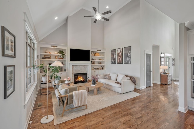 1009 Alpaca Dr, Spring Hill, TN 37174 - living area with ceiling fan, high vaulted ceiling, baseboards, and a warm lit fireplace