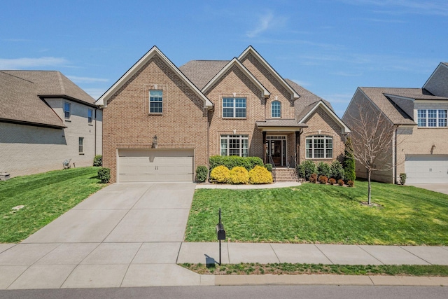 1009 Alpaca Dr, Spring Hill, TN 37174 - traditional-style home featuring concrete driveway, a garage, a front lawn, and brick siding