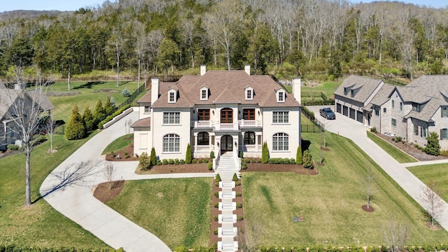 1506 Amesbury Ln, Franklin, TN 37069 - view of front of property featuring a chimney, driveway, a front yard, and a forest view