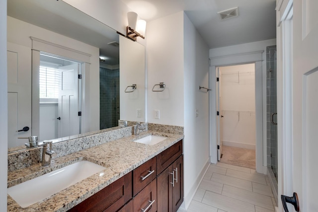 509D Chesterfield Ave, Nashville, TN 37212 - bathroom with a walk in closet, a stall shower, a sink, and visible vents