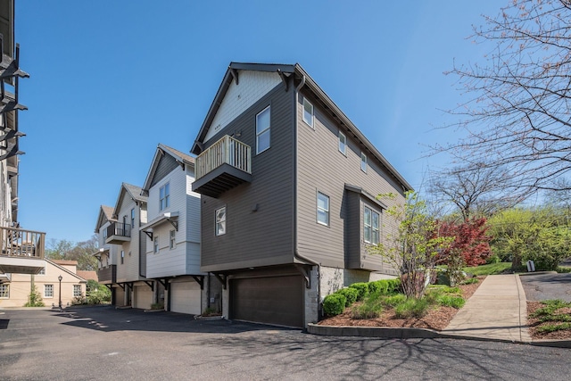 509D Chesterfield Ave, Nashville, TN 37212 - view of side of home featuring an attached garage, a residential view, and a balcony