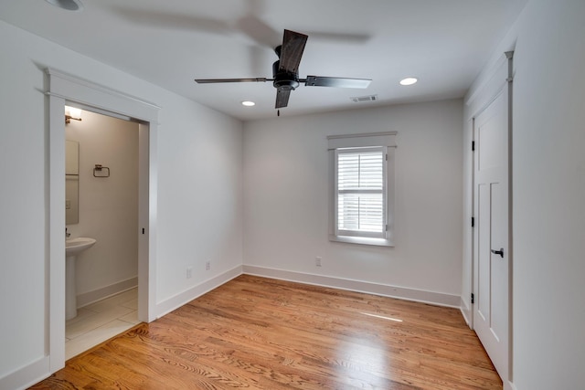 509D Chesterfield Ave, Nashville, TN 37212 - unfurnished bedroom with light wood-type flooring, baseboards, recessed lighting, ensuite bath, and visible vents