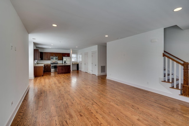 509D Chesterfield Ave, Nashville, TN 37212 - unfurnished living room with light wood-style flooring, a sink, visible vents, and recessed lighting