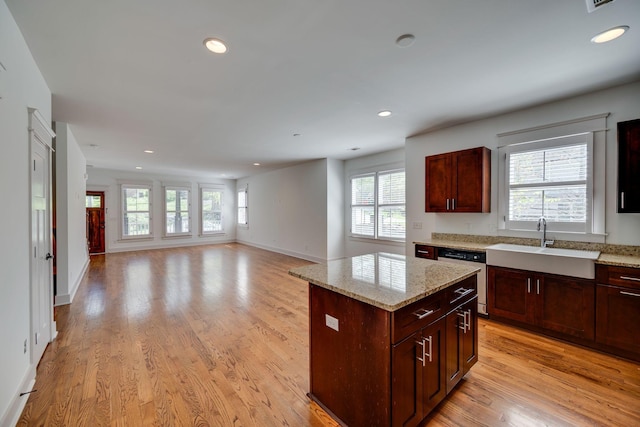 509D Chesterfield Ave, Nashville, TN 37212 - kitchen with stainless steel dishwasher, light wood-type flooring, a kitchen island, recessed lighting, and a sink