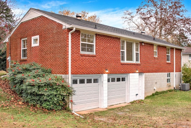 216 Belding Dr, Nashville, TN 37214 - view of property exterior with a garage, brick siding, central air condition unit, and a lawn
