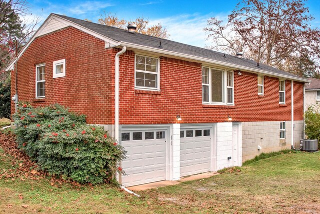 216 Belding Dr, Nashville, TN 37214 - view of side of property featuring a garage, a yard, brick siding, and central AC