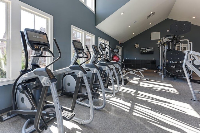 workout area with high vaulted ceiling and visible vents