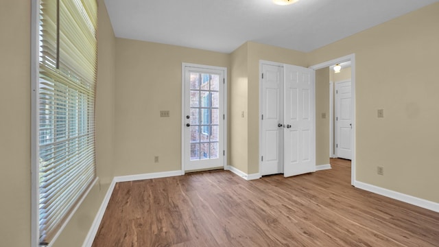 unfurnished bedroom featuring baseboards and wood finished floors