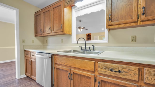 kitchen with light countertops, a ceiling fan, brown cabinetry, stainless steel dishwasher, and a sink
