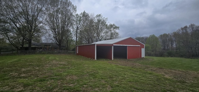 view of pole building featuring a yard and fence