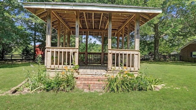 wooden terrace with fence and a lawn