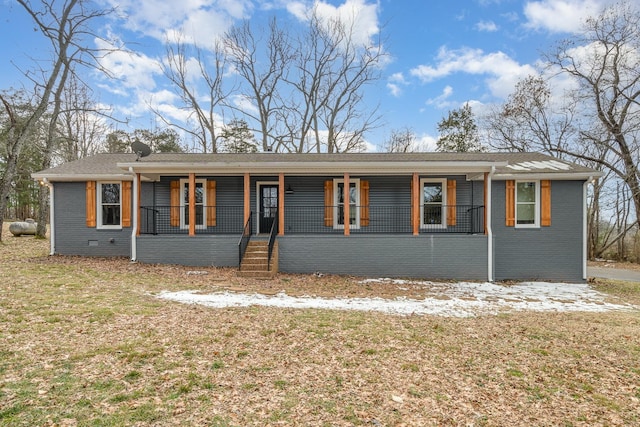 ranch-style home featuring brick siding and a porch
