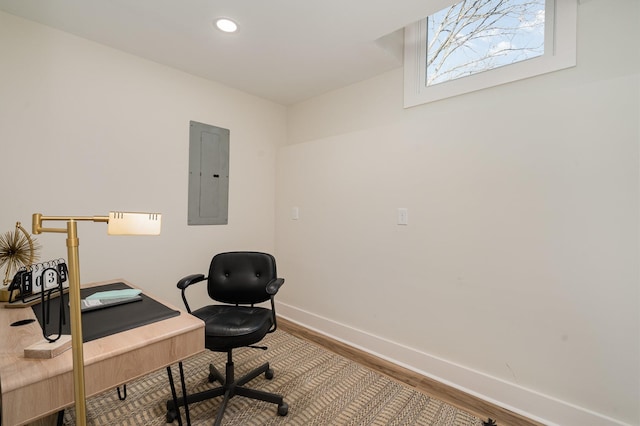 office area featuring electric panel, recessed lighting, baseboards, and wood finished floors