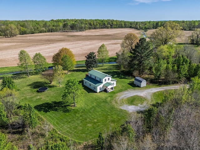 birds eye view of property with a forest view and a rural view