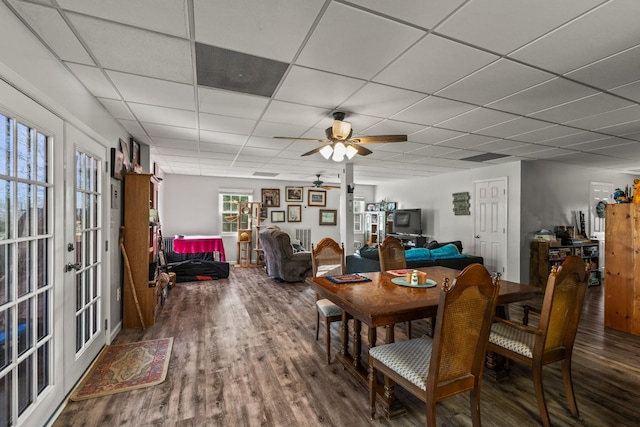dining space featuring a paneled ceiling, wood finished floors, and ceiling fan