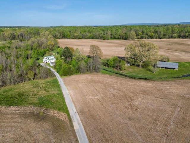 bird's eye view featuring a wooded view
