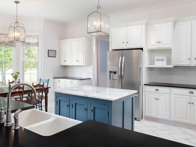 1698 Burke Hollow Rd, Nolensville, TN 37135 - kitchen with an inviting chandelier, stainless steel fridge, open shelves, white cabinets, and blue cabinets