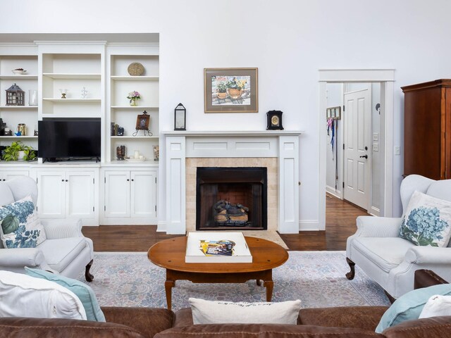 1698 Burke Hollow Rd, Nolensville, TN 37135 - living area featuring a tiled fireplace, dark wood-style flooring, and baseboards