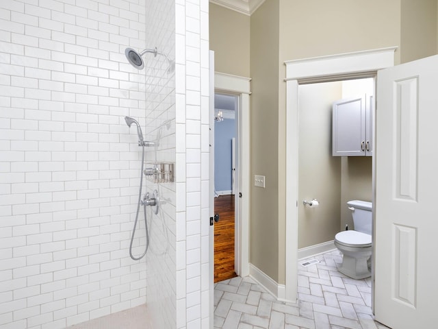 1698 Burke Hollow Rd, Nolensville, TN 37135 - bathroom featuring toilet, a tile shower, baseboards, and crown molding