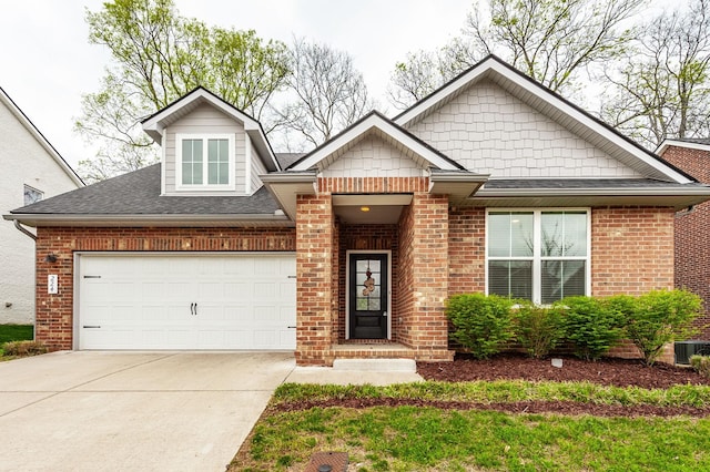 224 Griffin Ln, Gallatin, TN 37066 - craftsman inspired home featuring concrete driveway, cooling unit, brick siding, a garage, and a shingled roof