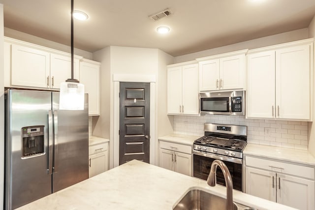 224 Griffin Ln, Gallatin, TN 37066 - kitchen with white cabinets, visible vents, appliances with stainless steel finishes, light stone counters, and decorative backsplash