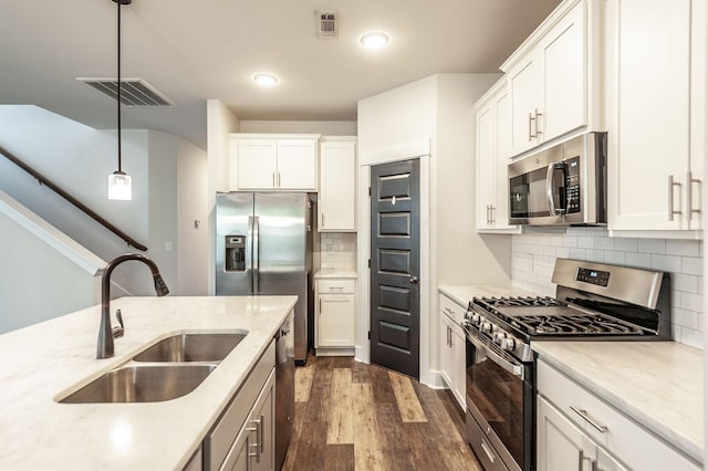 224 Griffin Ln, Gallatin, TN 37066 - kitchen with dark wood-type flooring, white cabinetry, visible vents, appliances with stainless steel finishes, and a sink