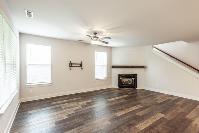 224 Griffin Ln, Gallatin, TN 37066 - unfurnished living room with dark wood-style flooring, baseboards, a large fireplace, visible vents, and ceiling fan