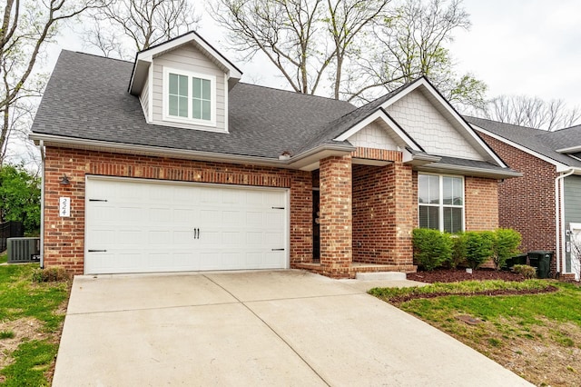 224 Griffin Ln, Gallatin, TN 37066 - view of front facade with roof with shingles, driveway, cooling unit, an attached garage, and brick siding