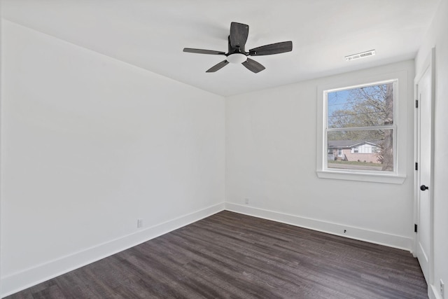 unfurnished room with ceiling fan, visible vents, baseboards, and dark wood finished floors
