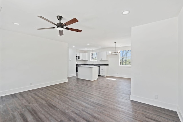 unfurnished living room featuring wood finished floors, ceiling fan, baseboards, and recessed lighting