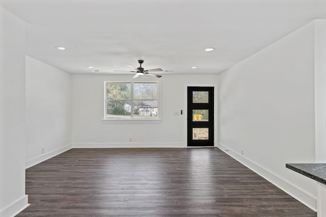 interior space featuring dark wood-type flooring, a ceiling fan, and recessed lighting