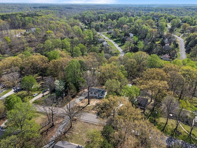 birds eye view of property with a wooded view